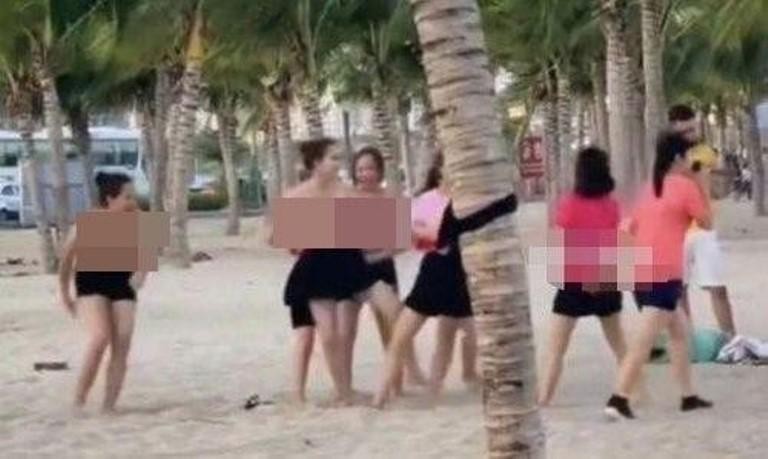 Nhóm du khách nữ cởi ngực trần vui chơi trên bãi biển. Ảnh: Cắt từ clip