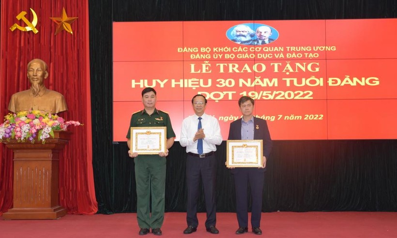 Đồng chí Trần Sâm (ngoài cùng bên phải) và đồng chí Vũ Minh được Thứ trưởng Phạm Ngọc Thưởng (ở giữa) trao Huy hiệu 30 năm tuổi Đảng