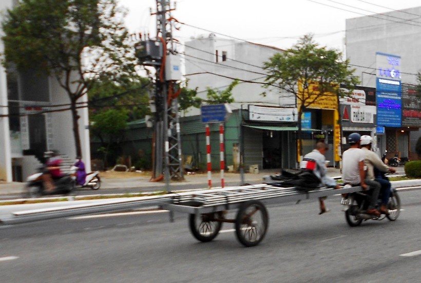 Xe máy chở “rờ moóc” cồng kềnh trên đường Nguyễn Hữu Thọ, quận Cẩm Lệ, TP Đà Nẵng (ảnh chụp ngày 24/2)